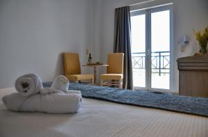 a hotel room with a bed with towels on it at Naiades Hotel by Estia in Kato Gouves