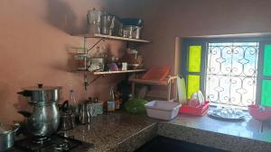 a kitchen with a counter top with a window at Ferme Panorama in Ouazzane