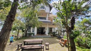 a house with a picnic table in front of it at Lotus Luxury Villa Da Lat in Da Lat +86 photos