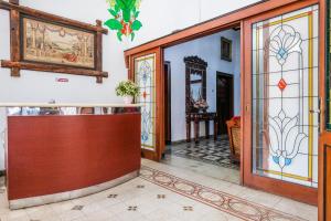 a lobby with a door and stained glass at Urbanview Hotel Griya Surya Malang by RedDoorz in Malang