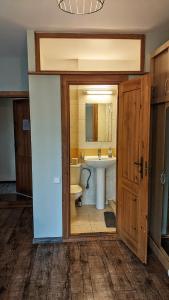 a bathroom with a sink and a toilet and a mirror at Guest House Kamara in Panevėžys +27 photos