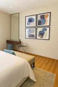 a bedroom with a bed and a chair and a mirror at Unique Suites in Riyadh