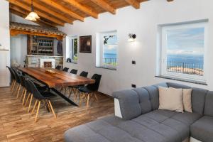a dining room with a table and a couch at Villa Izola in Izola
