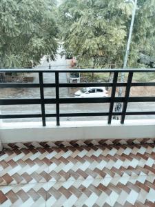 a balcony with a view of a car on a street at Syno in Lucknow