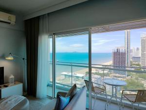 a hotel room with a view of the ocean at 2 Bedroom Condo R268 Veranda Pattaya Beachfront in Na Jomtien