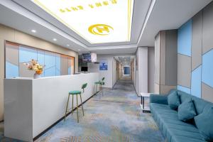 a lobby with a blue couch and a bar at Yinuo Hotel - Guangzhou Shangxiajiu Pedestrian Street, Yongqingfang Branch in Guangzhou