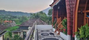 a balcony of a house with a tile floor at Sri Sedana Homestay in Sidemen