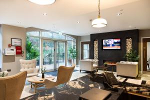 a living room with a fireplace and a tv at Rock Mill Studio Apartment 9 in Stoney Middleton
