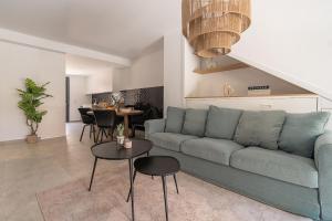 a living room with a blue couch and a table at Lagune apartment in Santiago de la Ribera