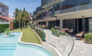 a swimming pool in front of a building at Lagune apartment in Santiago de la Ribera