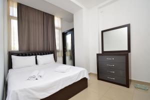 a bedroom with a bed with a mirror and a dresser at Stylish 3 room ap near republic square in Yerevan