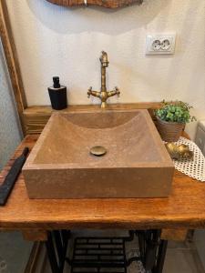 a stone sink on a wooden counter with a knife at La Novaci Porumbacu de Sus 270 in Porumbacu de Sus +99 photos