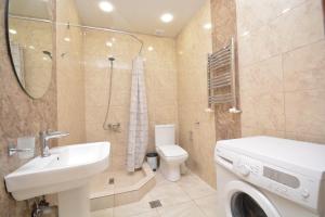 a bathroom with a sink and a washing machine at Stylish 3 room ap near republic square in Yerevan +26 photos