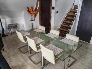 a dining room with a glass table and chairs at Historic Canal-Side Apartment in Schiedam