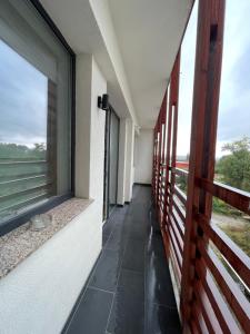 a corridor of a building with a large window at London Residence Deluxe 2-Bedroom in Suceava