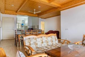 a dining room with a table and chairs at The Western Heights I Serviced Apartments I Pvt Balcony I Lift I Peacefull Area I Family Accomodation I Kasauli By Exotic Stays in Kasauli