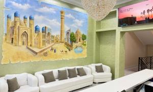 a living room with a white couch and a mural at Bukhara Vavilon Plaza Hotel in Bukhara