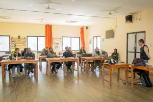 a group of people sitting at tables in a room at Nana Jungle Resort Near Chitwan National Park in Bharatpur
