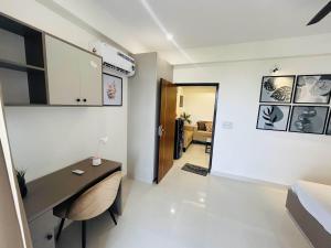 a living room with a desk in a room at Cozyआश्रय 1BHK with peaceful balcony in Siroli