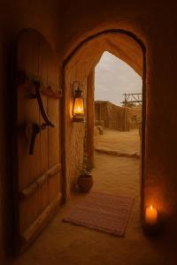 an entrance to a building with a lamp and a plant at Soléi Salt Caves in Siwa