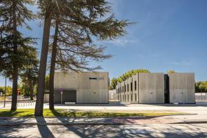 a large concrete building with trees in front of it at Kronoguest - Auto check-in in Castañares +12 photos