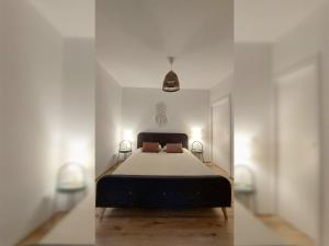 two pictures of a bedroom with a bed and two lights at Apartament Zakatek 2 z ogrodkiem i miejscem w garazu podziemnym in Bielsko-Biala