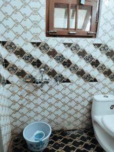 a bathroom with a black and white tiled wall at Syno in Lucknow +9 photos