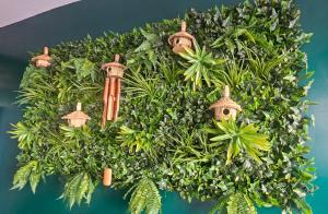 a wreath of green plants with birdhouses on it at Premium Flat Agadir - Immersive rental --- Maison Bleue --- Fast wifi in Agadir