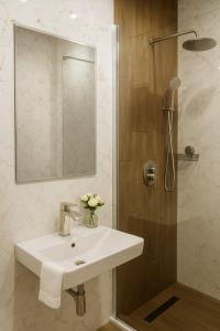 a bathroom with a white sink and a shower at Studio Apartment City Dream in Stara Zagora +24 photos