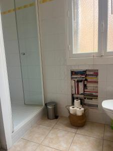 a bathroom with a shower and a sink and a book shelf at Bedroom in Paris in Paris +9 photos