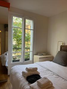 a bedroom with a bed with towels on it at Bedroom in Paris in Paris