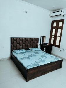 a bedroom with a large bed with a blue comforter at Syno in Lucknow
