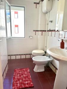 a bathroom with a toilet and a sink at San Lorenzo Beach in Marina di San Lorenzo