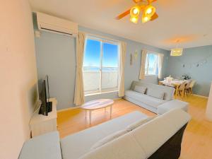 ein Wohnzimmer mit Sofa und Fernseher in der Unterkunft The feel Kincho cho Seaside villa - sea - / Vacation STAY 26185 in Yaka