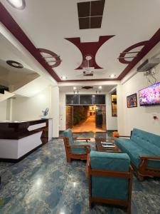 a living room with a couch and a table at Shree Ramanam Palace in Ayodhya
