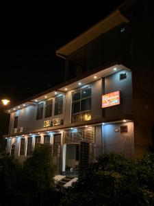 a building with lights on it at night at Shree Ramanam Palace in Ayodhya