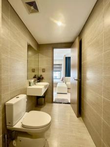 a bathroom with a toilet and a sink and a mirror at Shi House -Cozy 2BR, S1001 Beautiful Vinhomes Q9 in Ho Chi Minh City