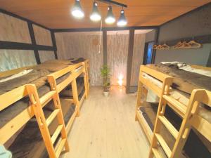 a room with three bunk beds in a house at Sea Hale - Vacation STAY 7734 in Yuzawa