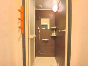 a bathroom with a shower with a sink and a mirror at Sea Hale - Vacation STAY 7734 in Yuzawa +18 photos