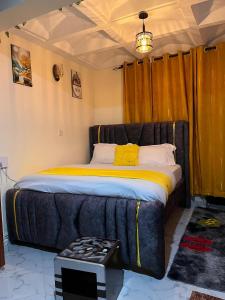 a bedroom with a large bed with a couch at Happy Homes Airbnbs- Kikuyu in Nairobi
