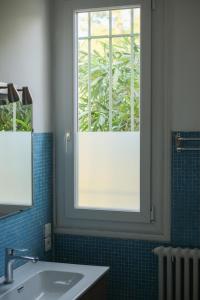 a bathroom with a window and a sink at MAS Élancia in Argelès-sur-Mer +52 photos