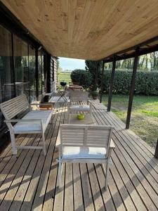 a wooden deck with two chairs and a table at le domaine des cigales in Cavaillon