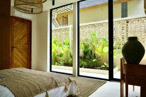 Postel nebo postele na pokoji v ubytování Ubud Dzen Villa 4