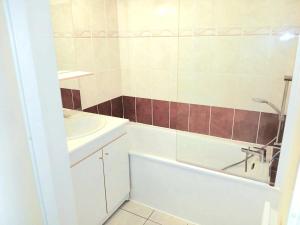 a bathroom with a sink and a bath tub and a sink at F2 plein sud proche plage du débarquement in Port-en-Bessin-Huppain