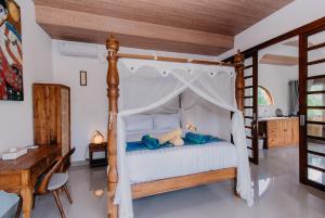 a bedroom with a bed with a canopy at 28 Degrees Lembongan in Nusa Lembongan +24 photos