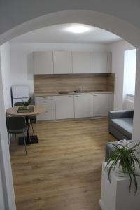 a kitchen and living room with a table and a couch at KAVE Obchodná Apartments in Bratislava +9 photos