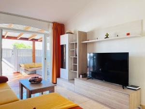 a living room with a large flat screen tv at Santa Barbara Tropical by Alquiler de Sueno - 2 private terraces in Playa del Ingles