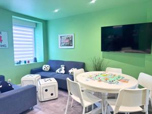 a living room with a blue couch and a table at Le Moonhomepoly, proche centre ville et gare in Mulhouse