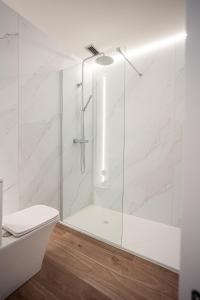 a bathroom with a shower with a glass door at Kronoguest - Auto check-in in Castañares