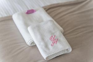 a pair of white towels on a bed at Your Holidays Aquamarina Prima, Parking Gratis in Międzyzdroje +53 photos